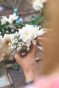 Cropped hands of person holding flowers