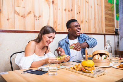 Young couple sitting on table