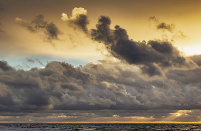Low angle view of dramatic sky over sea