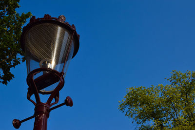 Low angle view of street light against clear blue sky