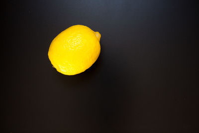 Close-up of apple against orange background