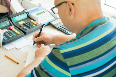 Worker with cash register at counter