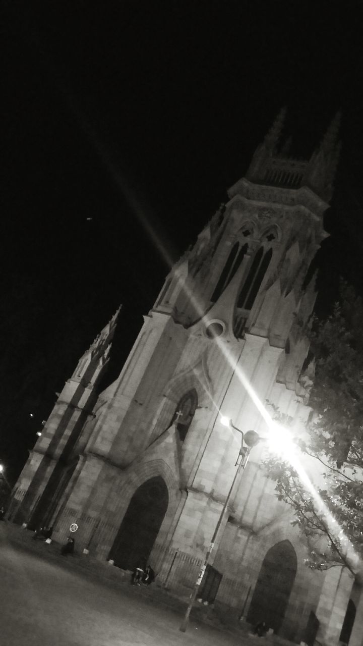 architecture, built structure, building exterior, low angle view, night, history, religion, place of worship, famous place, church, sky, spirituality, travel destinations, clear sky, illuminated, city, building, old, tower