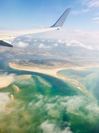 Aerial view of airplane flying in sky