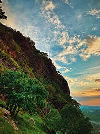 Scenic view of rocks by sea against sky