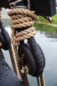Close-up of rope tied on wooden post