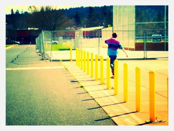 Full length of woman standing by railing