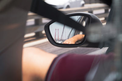 Close-up of hand on side-view mirror