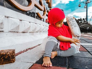 A little girl playing with her bottle