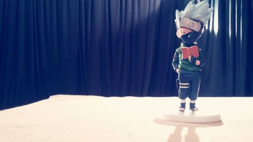 Boy standing in front of curtain