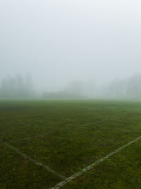 Scenic view of field against sky during foggy weather