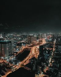 High angle view of illuminated city buildings at night