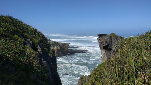 Scenic view of sea against clear blue sky