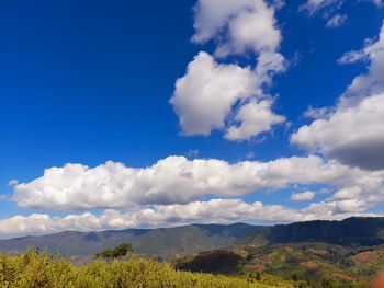Scenic view of mountains against blue sky
