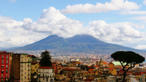 Townscape by mountains against sky