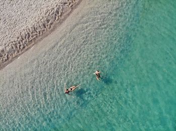 High angle view of people swimming in sea