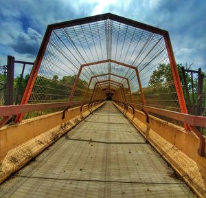 Footbridge against sky