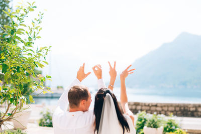 Rear view of man and woman against clear sky