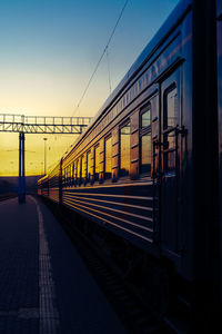 Train at railroad station against clear sky