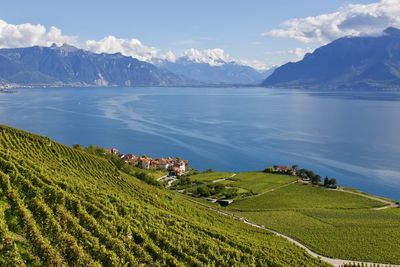 Scenic view of sea and mountains against sky