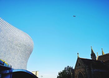 Low angle view of a building against clear blue sky