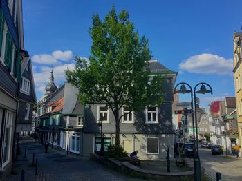Street amidst buildings in town against sky