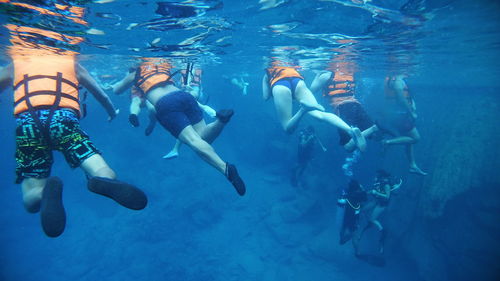 Group of people swimming in sea