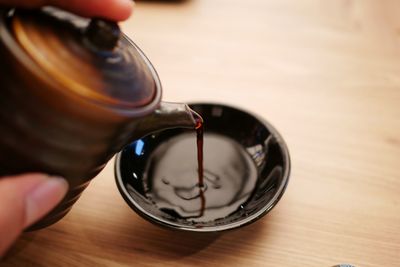 High angle view of person holding drink on table