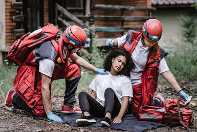 Paramedic workers rescuing woman during disaster