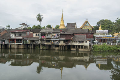 Reflection of building in lake against sky