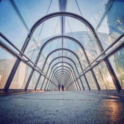 Rear view of man with reflection of building