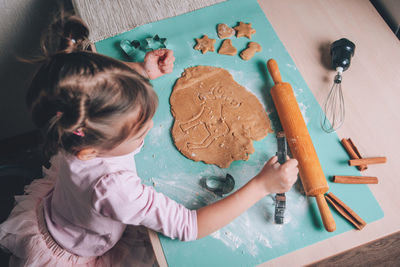 High angle view of girl preparing food on table