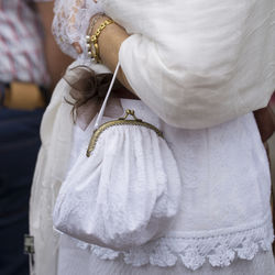 Midsection of woman holding purse