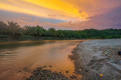 Scenic view of beach against sky during sunset