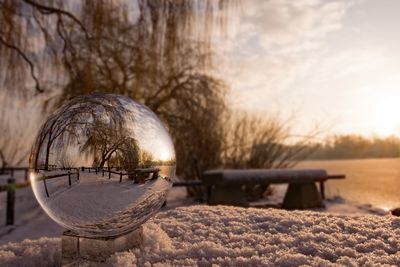 Close-up of crystal ball on snow outdoors