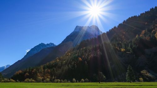 Scenic view of mountains against clear sky on sunny day