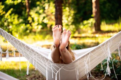 Woman relaxing in hammock at yard