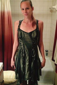 Portrait of young woman standing in mirror