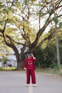 Rear view of man standing on footpath