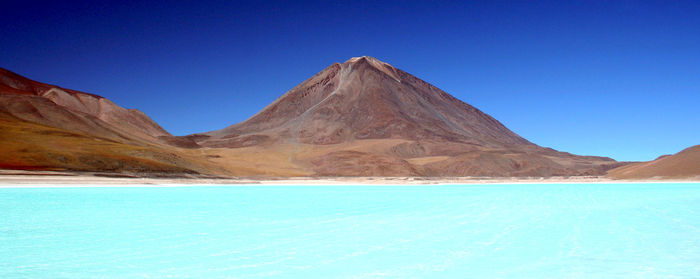 Scenic view of mountains against clear blue sky