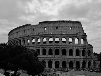 Low angle view of historical building against cloudy sky