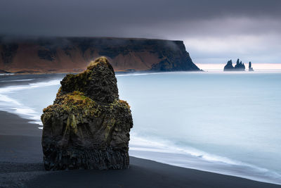 Looking to reynisfjara black sand beach and reynisdrangar during sunrise on a stormy morning