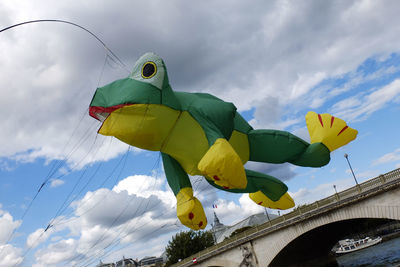 Low angle view of frog balloon with strings over pont des invalides against sky