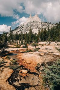 Scenic view of mountains against cloudy sky