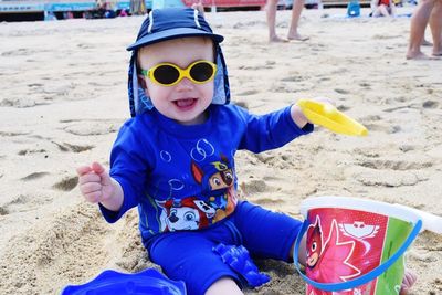 Portrait of boy wearing sunglasses at beach