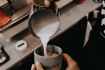 Midsection of person holding coffee cup