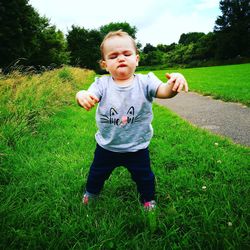 Girl standing on grassy field