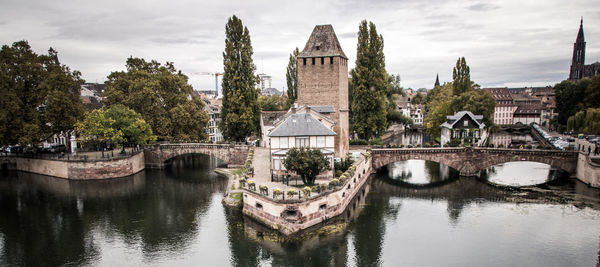 View of arch bridge over river in town