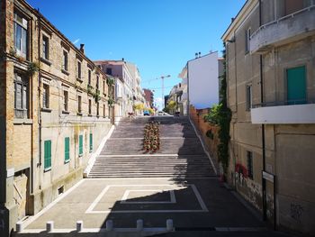 Street amidst buildings against sky in city