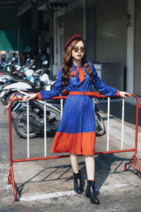 Portrait of smiling young woman standing outdoors